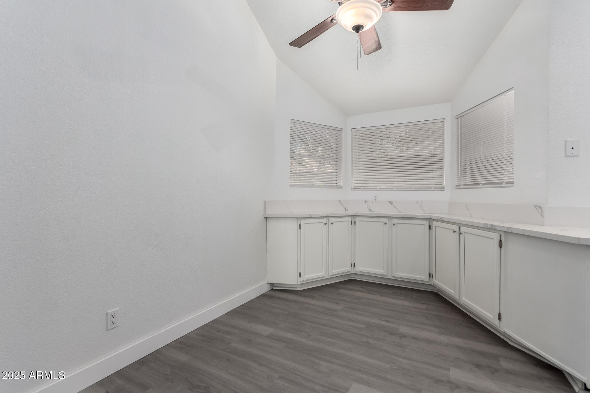 4162 East Wayland Road Phoenix, AZ 85040 - Photo 9 of 36 a view of a kitchen with wooden floor and white walls