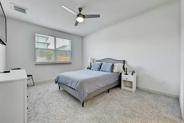 a bedroom with a bed and a table