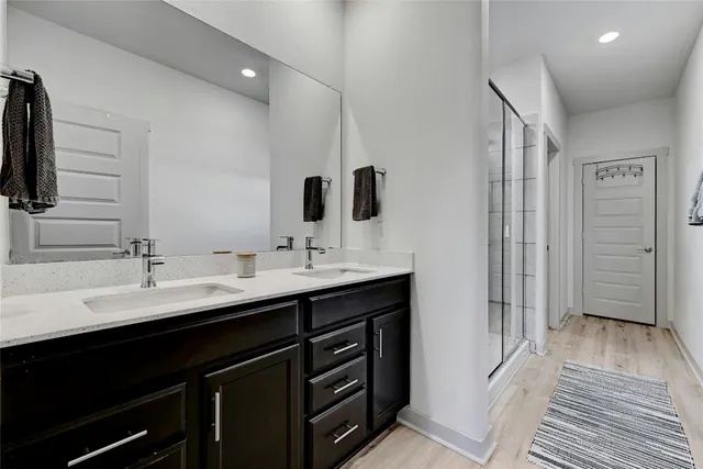 a bathroom with a double vanity sink a and mirror