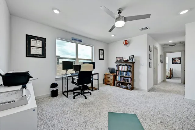 a view of a livingroom with workspace and a window