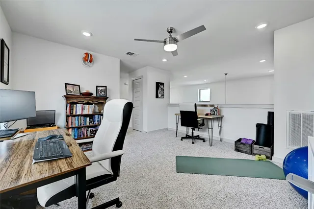 a living room with furniture and a view of kitchen