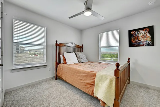 a bed sitting in a bedroom next to a window