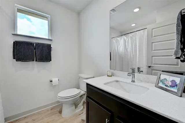 a bathroom with a sink a toilet and mirror