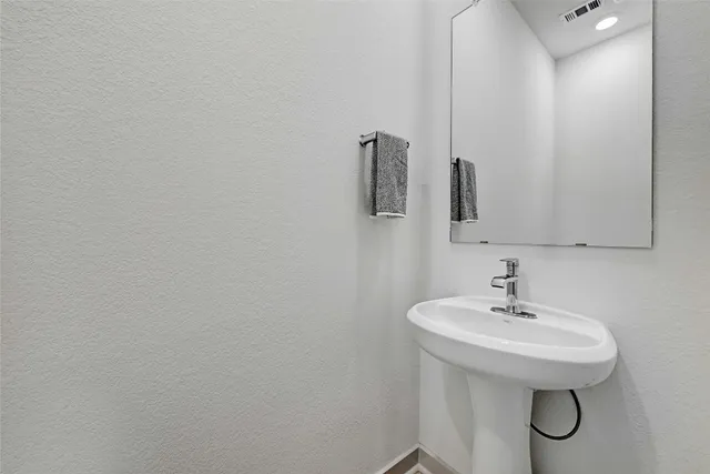 a bathroom with a sink and mirror