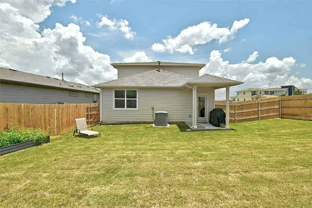 a view of a house with a yard and sitting area