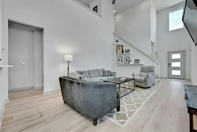a living room with furniture and a wooden floor