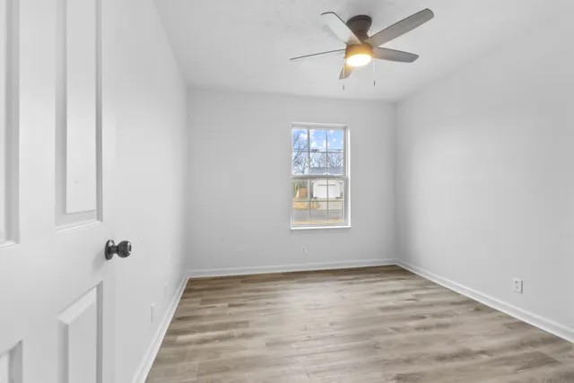 a view of room with a ceiling fan and window