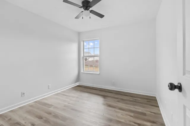 wooden floor in an empty room with a window