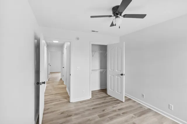 a bathroom with a granite countertop sink toilet and a mirror