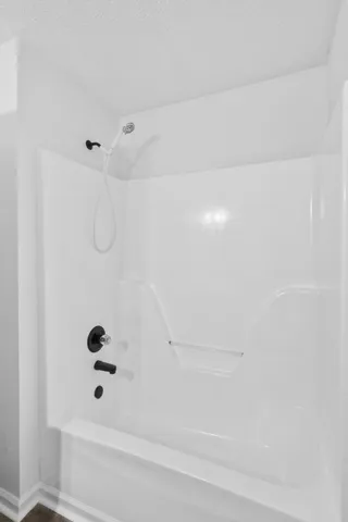 a bathroom with a granite countertop sink a toilet and a mirror