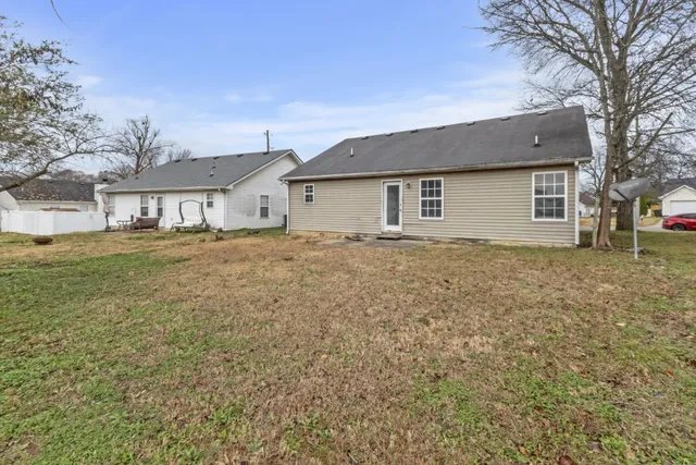 a yard that is sitting in front of a house
