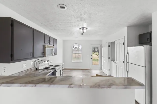 a view of a livingroom with furniture and cabinets
