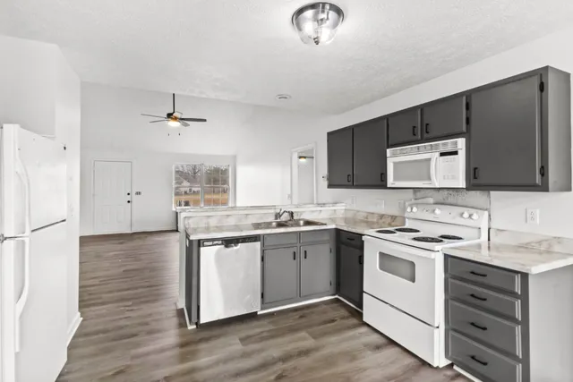a kitchen with a sink stove and microwave