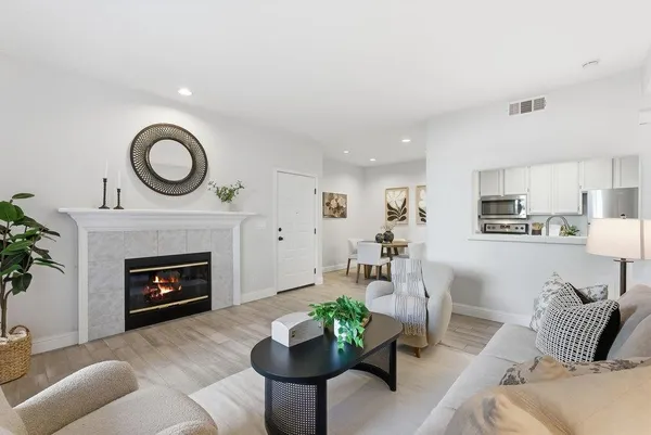 a living room with furniture and a fireplace