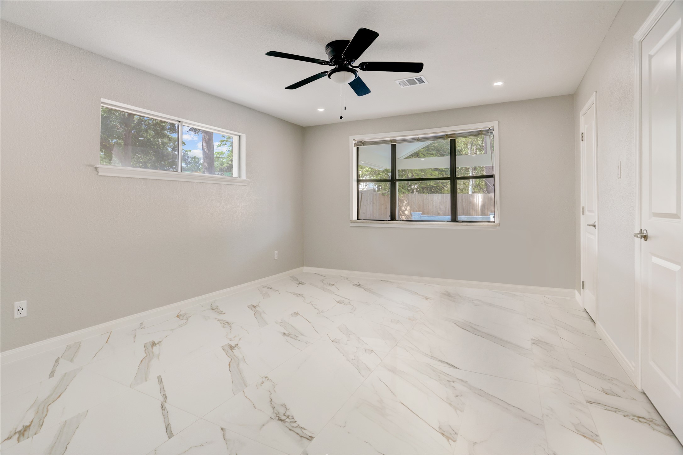 6502 Cypress Point Drive Houston, TX 77069 - Photo 14 of 33 The first-floor primary suite is a private retreat with serene pool views, ample storage, and a luxurious en-suite bathroom.