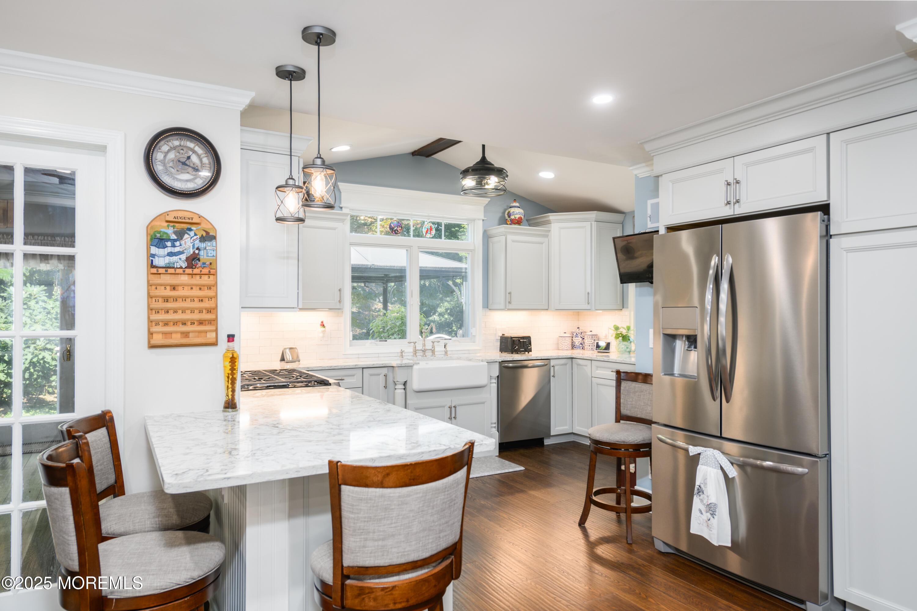 101 Millbrook Place Middletown, NJ 07748 - Photo 16 of 58 a kitchen with refrigerator a stove a dining table and chairs with wooden floor