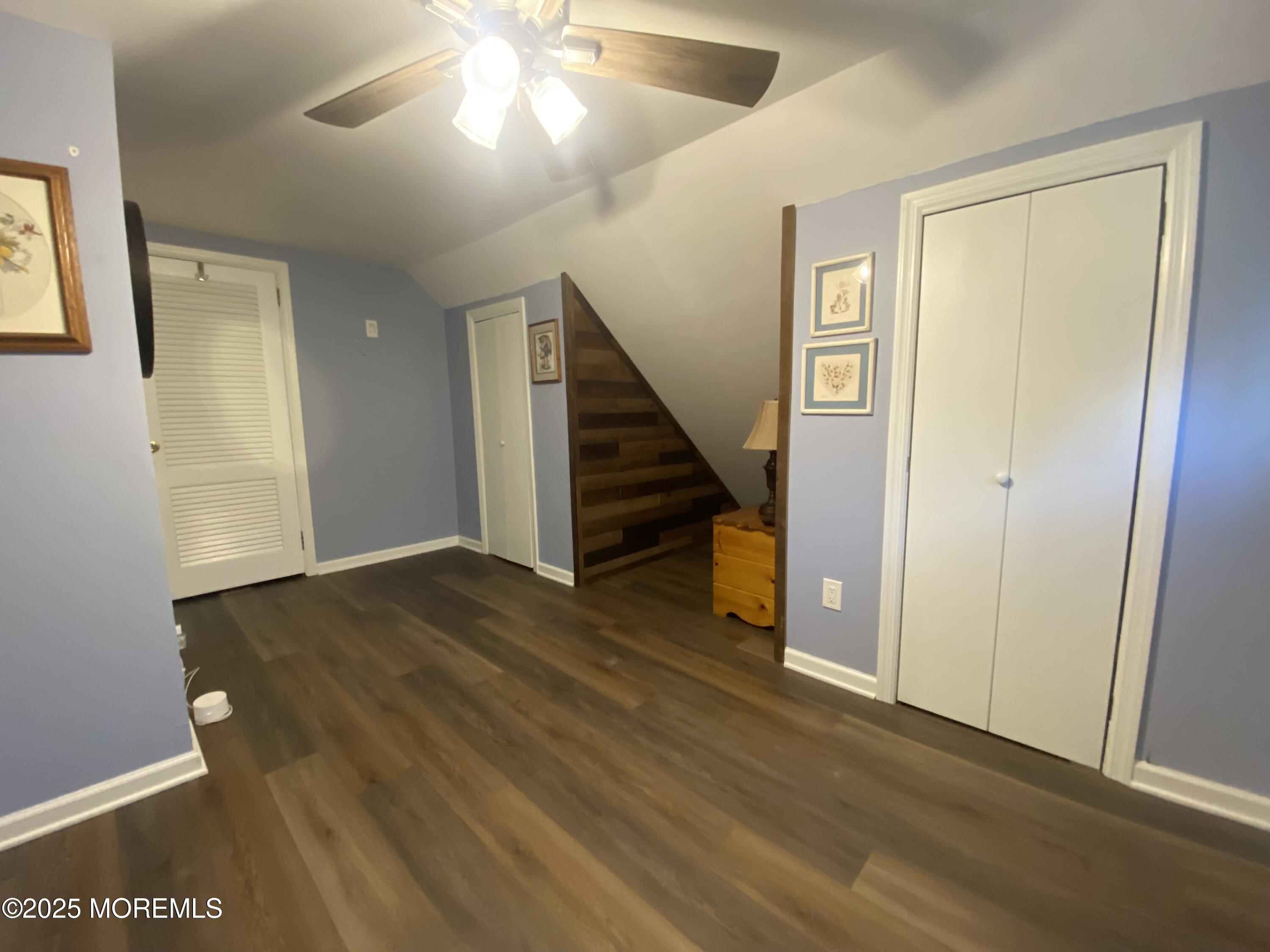 101 Millbrook Place Middletown, NJ 07748 - Photo 32 of 58 a view of an empty room with wooden floor and stairs