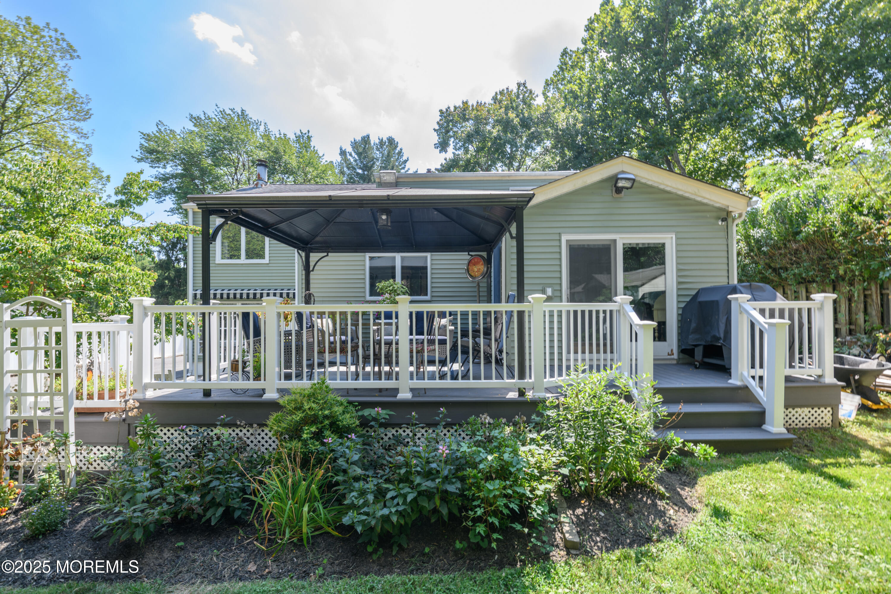 101 Millbrook Place Middletown, NJ 07748 - Photo 37 of 58 a view of a house with a deck and furniture