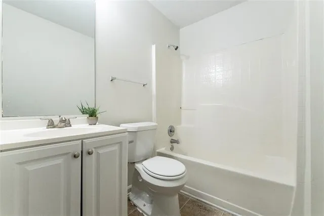 a view of a house with backyard and trees