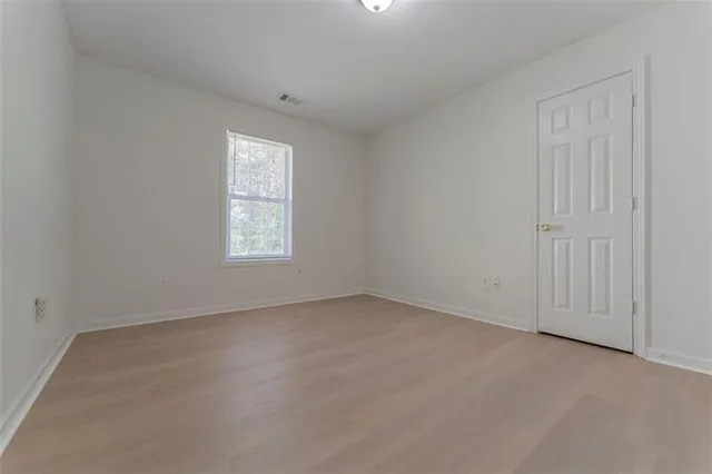 a view of a house with a wooden fence