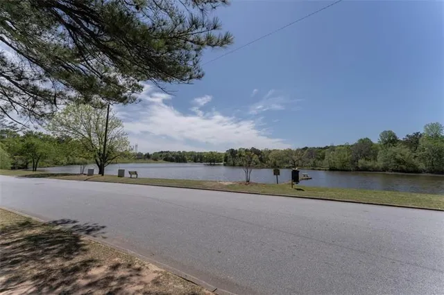 an empty room with chandelier fan and windows