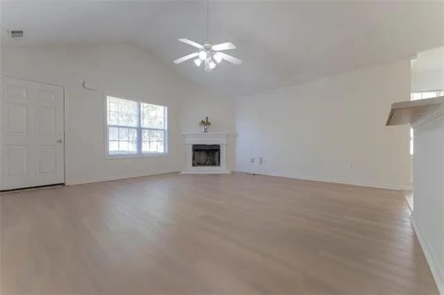a large white kitchen with a sink and cabinets