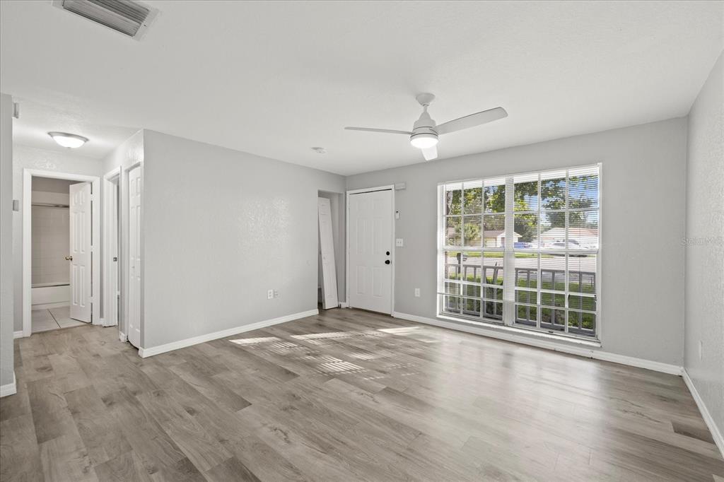 7445 Daggett Terrace New Port Richey, FL 34655 - Photo 11 of 35 a view of an empty room with a window and wooden floor