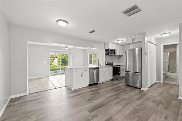a kitchen with a refrigerator and a stove top oven