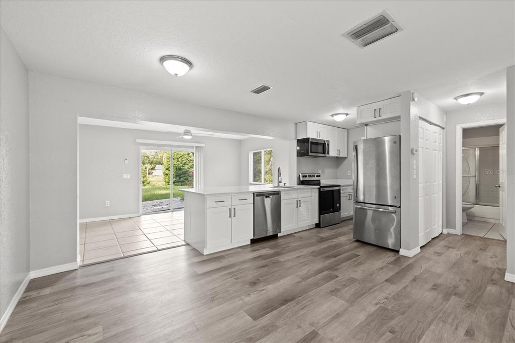 7445 Daggett Terrace New Port Richey, FL 34655 - Photo 12 of 35 a kitchen with a refrigerator and a stove top oven