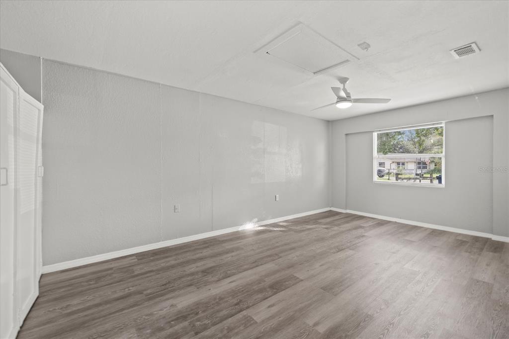 7445 Daggett Terrace New Port Richey, FL 34655 - Photo 18 of 35 an empty room with wooden floor and window