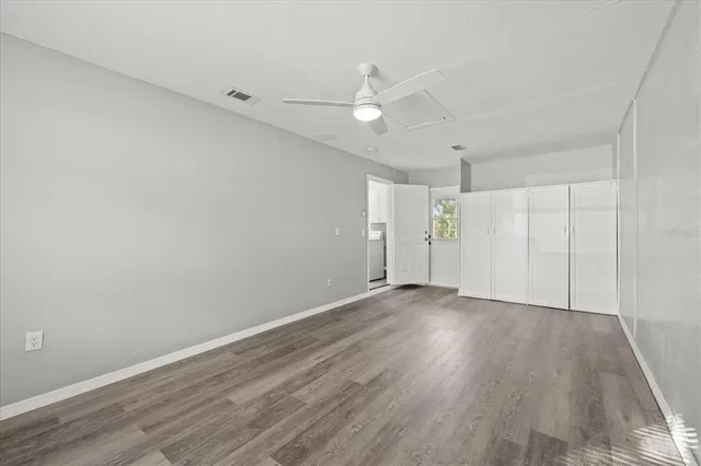 a view of an empty room with wooden floor