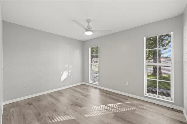 an empty room with windows and closet