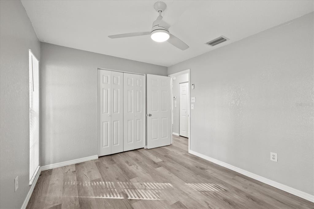 7445 Daggett Terrace New Port Richey, FL 34655 - Photo 22 of 35 a view of an empty room with wooden floor