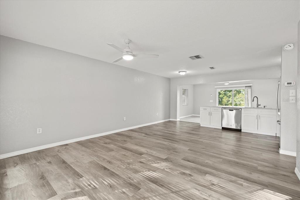 7445 Daggett Terrace New Port Richey, FL 34655 - Photo 23 of 35 a view of an empty room with a window and wooden floor
