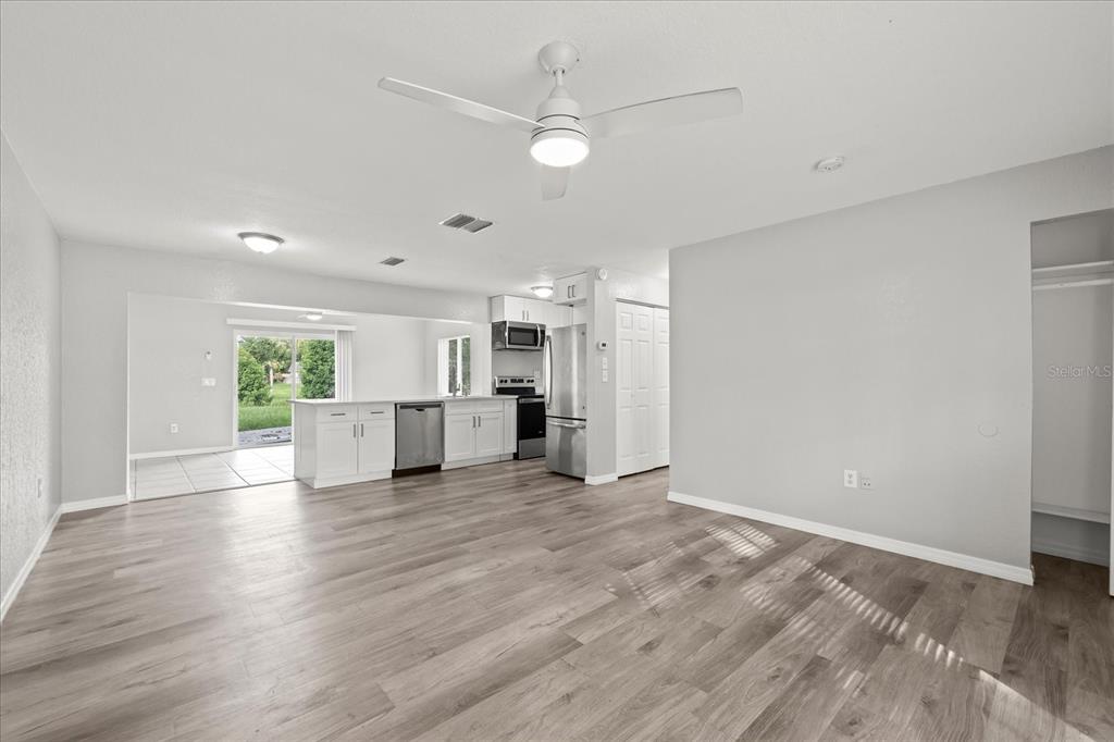 7445 Daggett Terrace New Port Richey, FL 34655 - Photo 5 of 35 a view of a kitchen with wooden floor and a window
