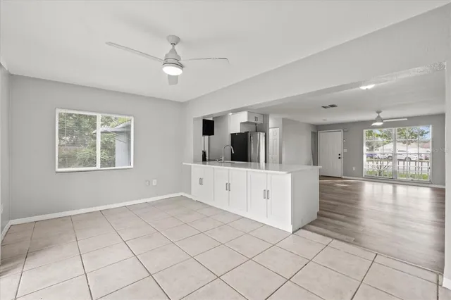 a view of an empty room with window and cabinet