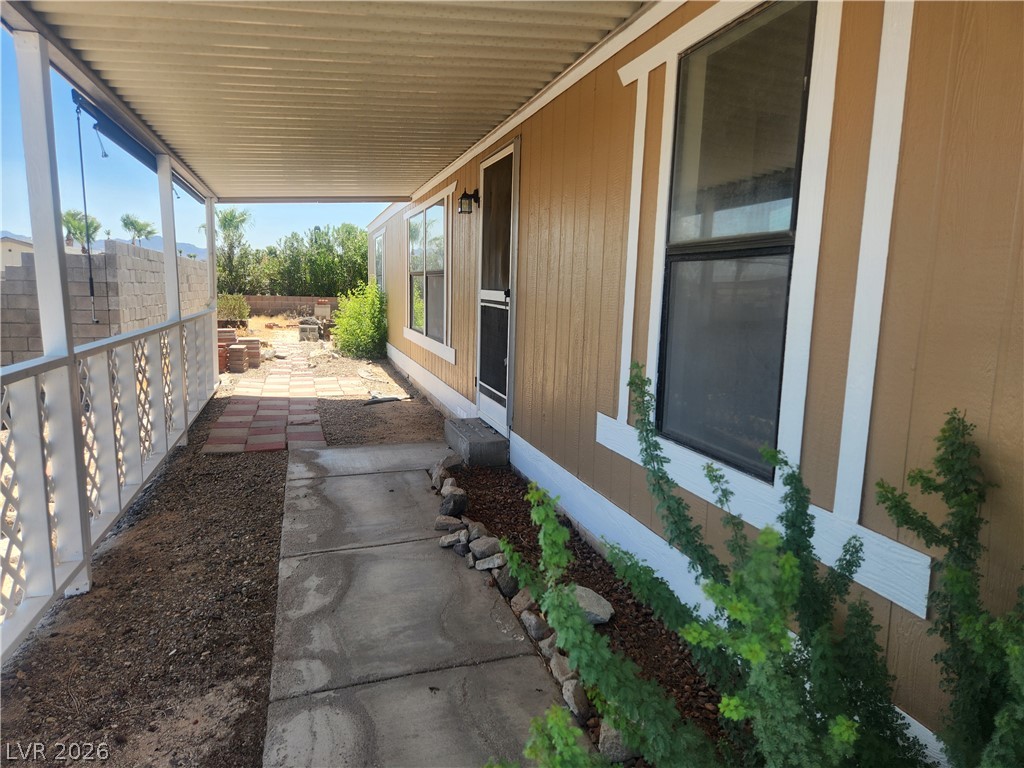 3189 Del Monte Street Laughlin, NV 89029 - Photo 4 of 32 An inviting covered patio offers a shaded retreat alongside the residence.