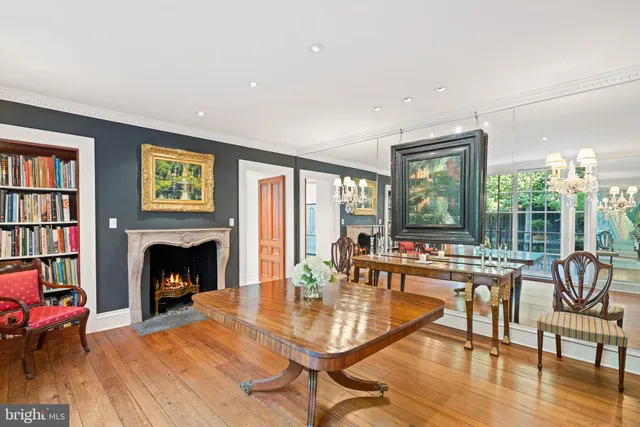 a living room with fireplace furniture and a large window