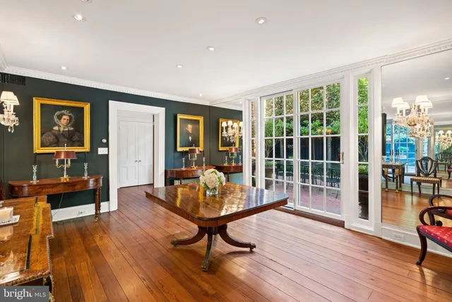a living room with furniture windows and wooden floor