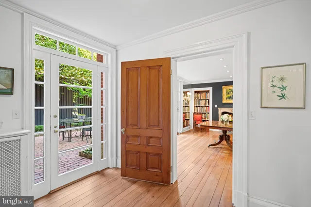 a view of a hardwood floor and windows in an empty room