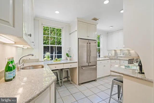 a kitchen with appliances cabinets and furniture