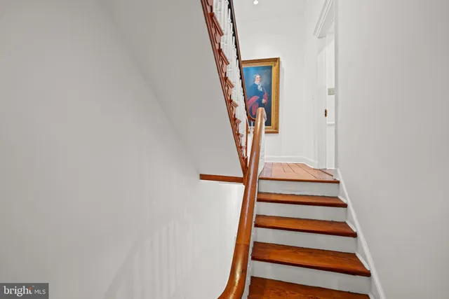 a room with a book shelf and wooden floor