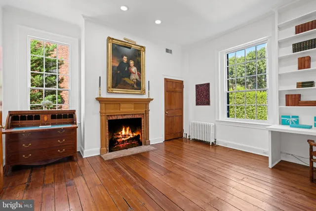 a bedroom with a bed and a flat tv screen on dresser