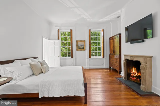 a bathroom with a sink a potted plant and a window