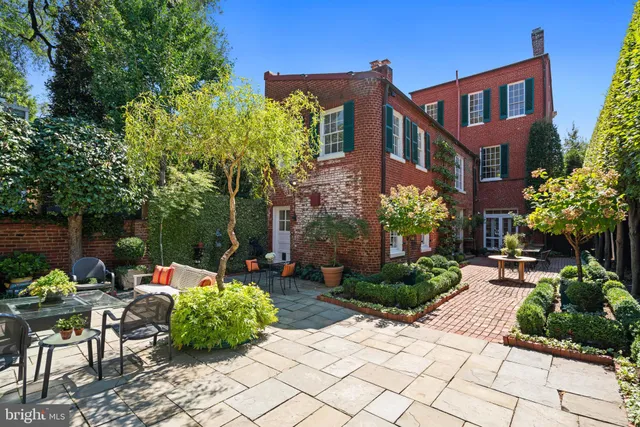 a view of a house with backyard and sitting area