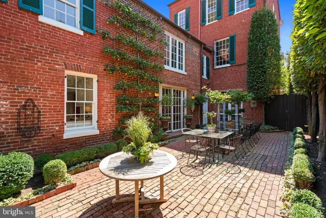a view of a chairs and table in backyard of the house