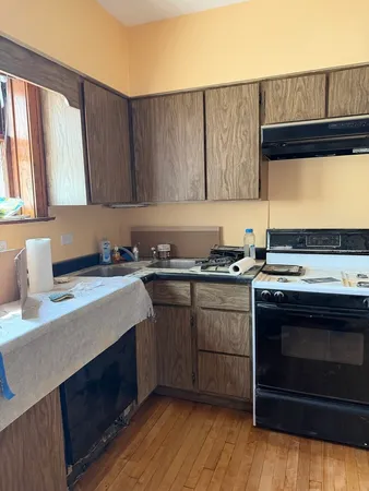 a kitchen with a sink stove and cabinets