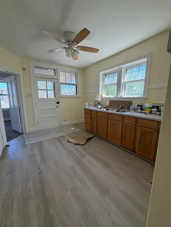 a view of kitchen with sink and wooden floor