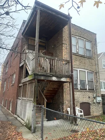 a view of a house with iron stairs