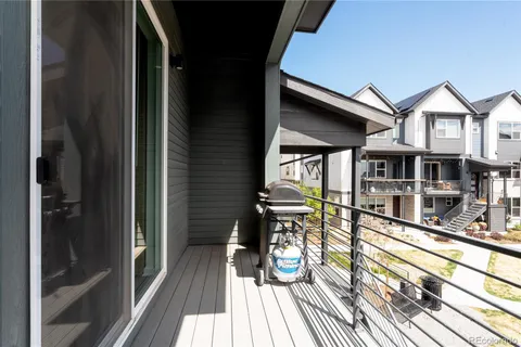 a view of a balcony with dining area and glass door